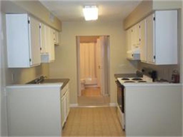 7 Beal's Cove Road, Unit 7G Hingham, MA 02043 - Photo 3 of 12 a room with a stove a sink and a refrigerator