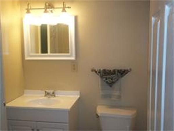 7 Beal's Cove Road, Unit 7G Hingham, MA 02043 - Photo 4 of 12 a bathroom with a sink and mirror with toilet