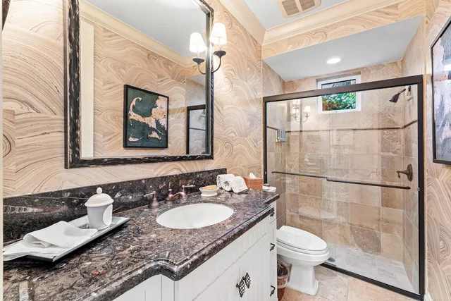 a bathroom with a toilet sink and mirror