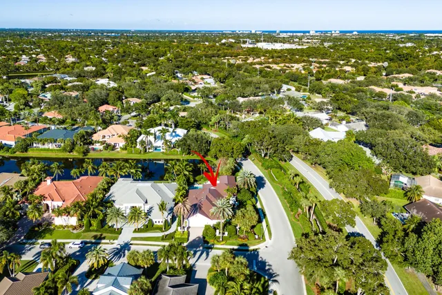 an aerial view of a house with swimming pool and garden