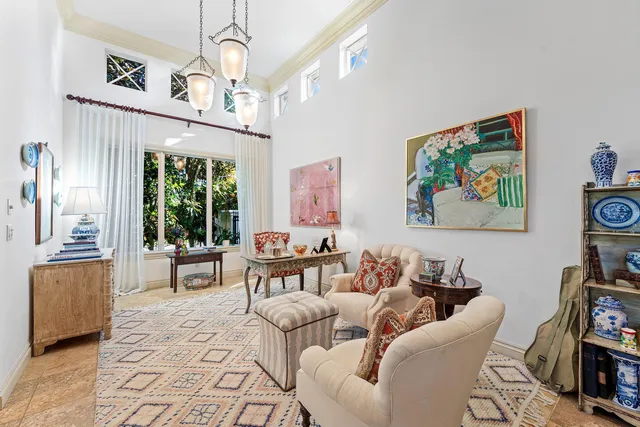 a living room with furniture a chandelier and a flat screen tv