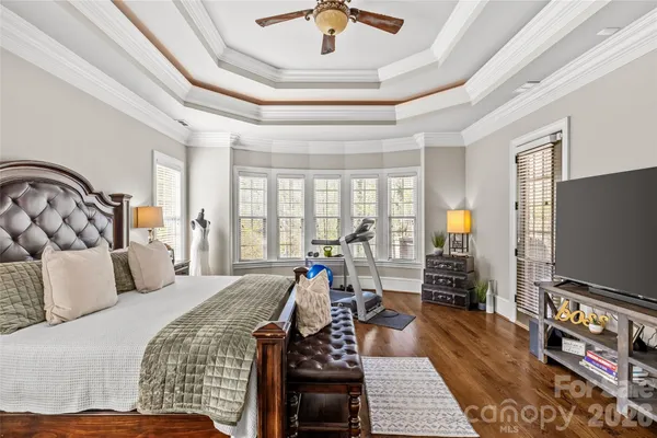 a bedroom with furniture and a flat screen tv