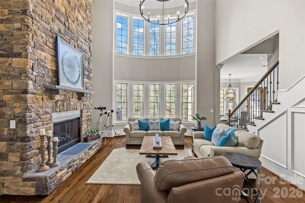 a living room with furniture fireplace and a chandelier