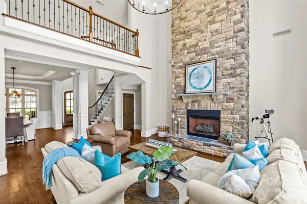 a living room with furniture a fireplace and a potted plant