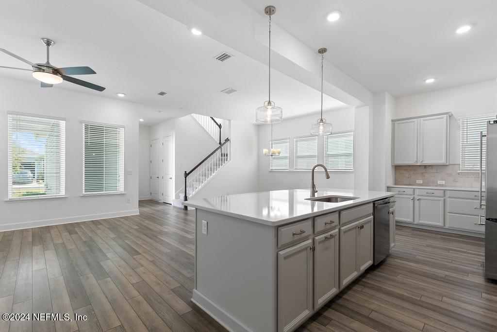 116 Alston Dr Street St. Augustine, FL 32092 - Photo 11 of 58 a kitchen with kitchen island granite countertop a sink appliances and wooden floor