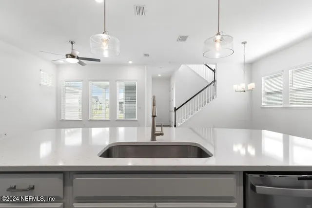 a kitchen with white cabinets and a sink