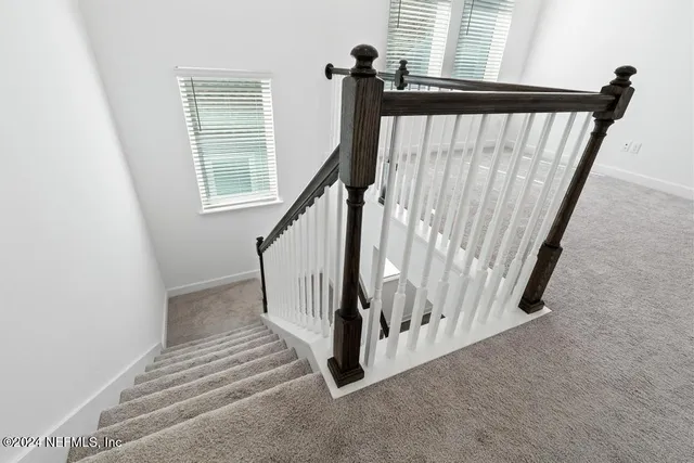 a bedroom with a large bed couch and a window