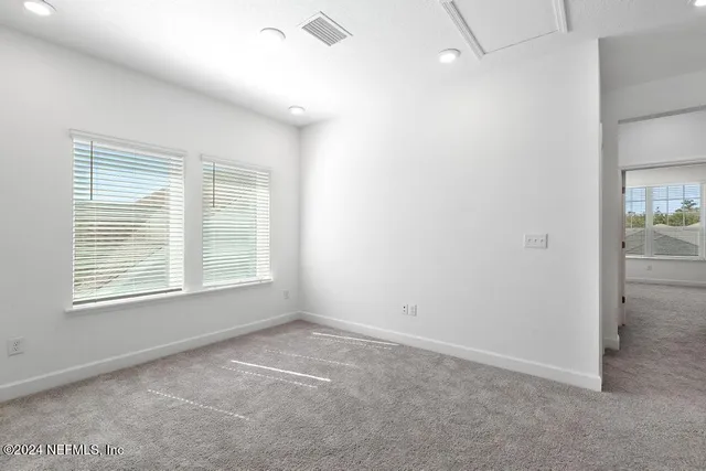 a bathroom with a granite countertop sink a mirror and shower
