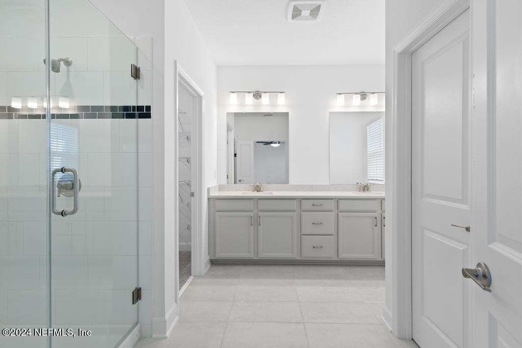 116 Alston Dr Street St. Augustine, FL 32092 - Photo 30 of 58 a bathroom with a granite countertop sink a mirror and shower