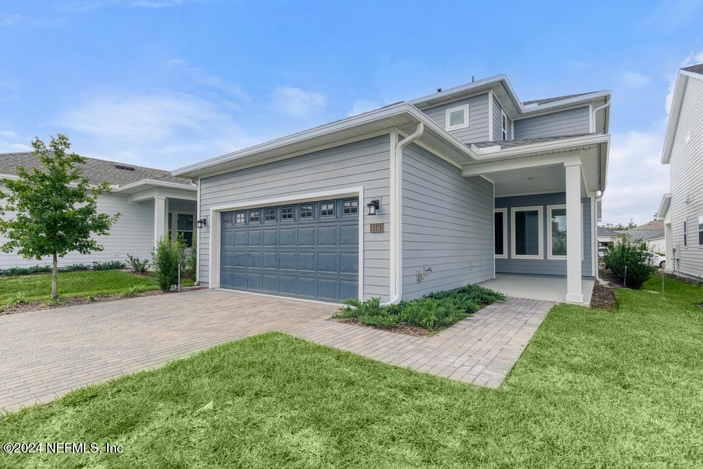 116 Alston Dr Street St. Augustine, FL 32092 - Photo 3 of 58 a front view of a house with garden