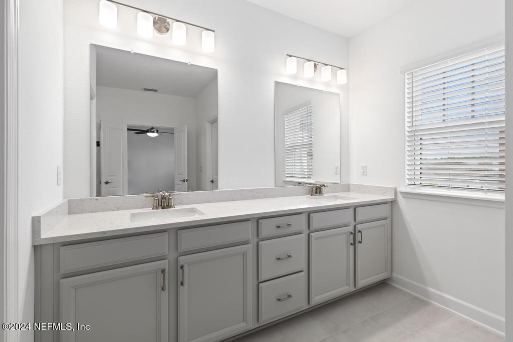 116 Alston Dr Street St. Augustine, FL 32092 - Photo 31 of 58 a bathroom with double sink and a mirror