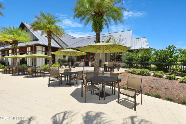 a view of a house with backyard porch and sitting area