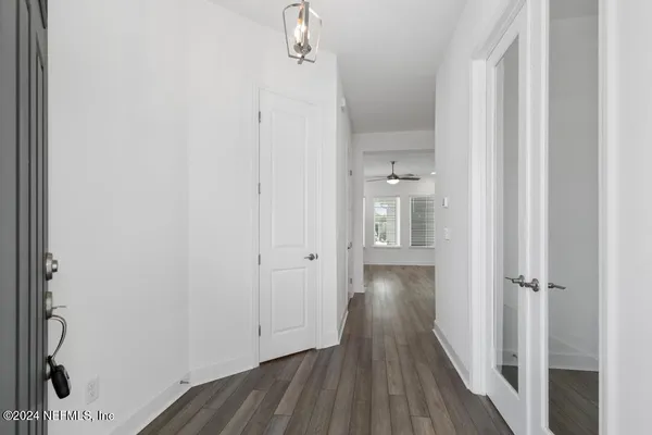 a view of a hallway with wooden floor