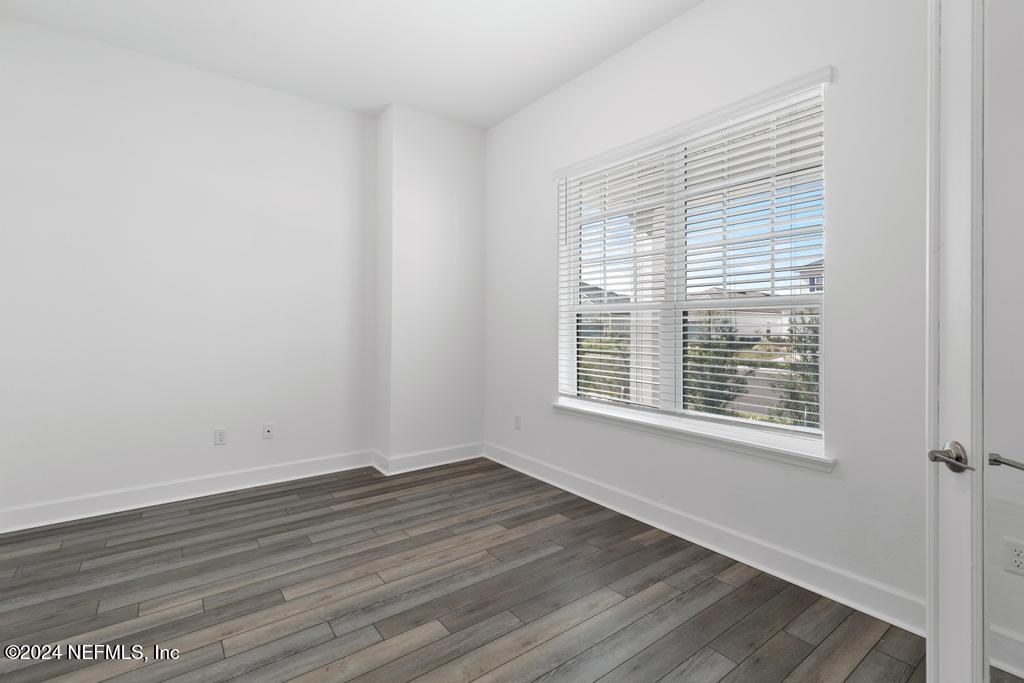 116 Alston Dr Street St. Augustine, FL 32092 - Photo 8 of 58 a view of an empty room with wooden floor and a window