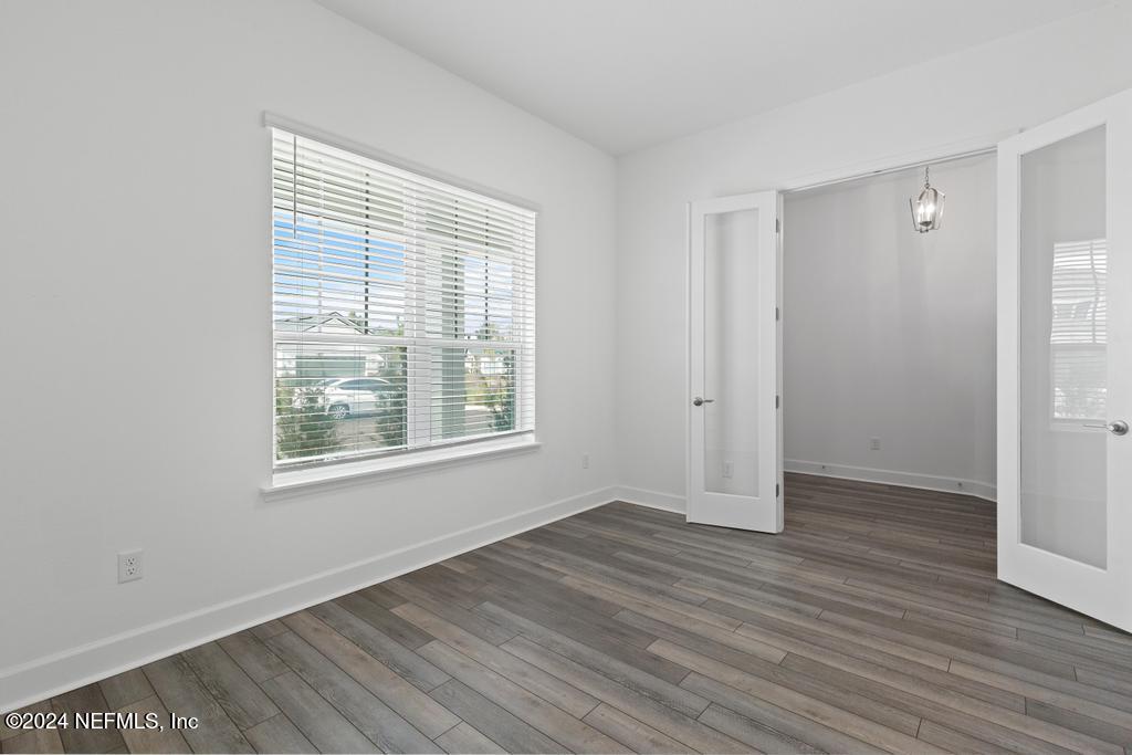 116 Alston Dr Street St. Augustine, FL 32092 - Photo 9 of 58 an empty room with wooden floor and windows