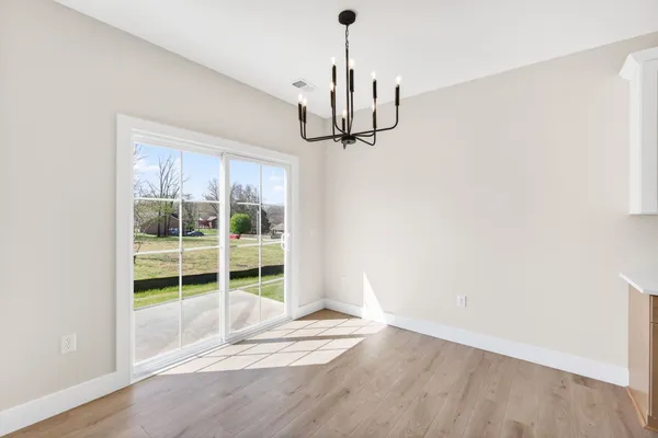 a view of a hallway with closet and wooden floor