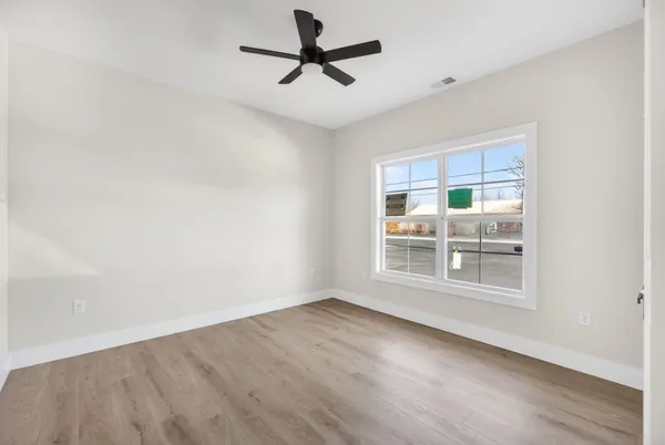 wooden floor in an empty room with a window