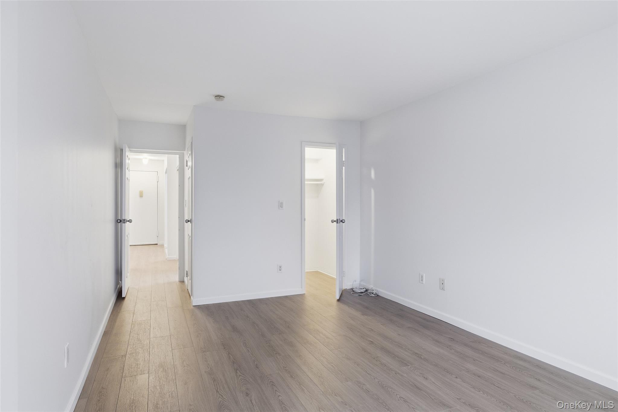55 Monroe Boulevard, Unit 2L Long Beach, NY 11561 - Photo 19 of 25 a view of a room with wooden floor and white walls