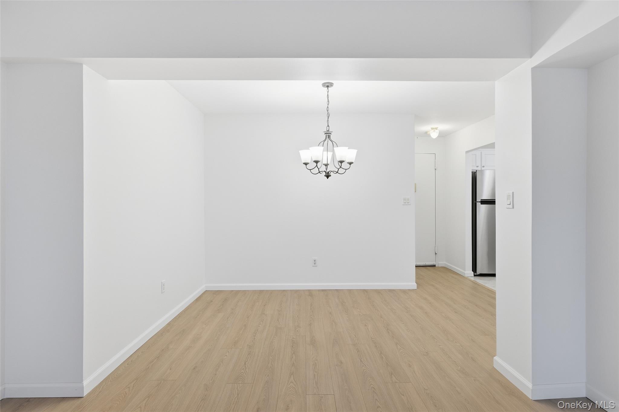 55 Monroe Boulevard, Unit 2L Long Beach, NY 11561 - Photo 6 of 25 wooden floor in an empty room