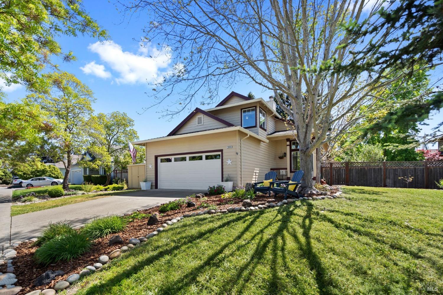 a front view of a house with a yard and trees