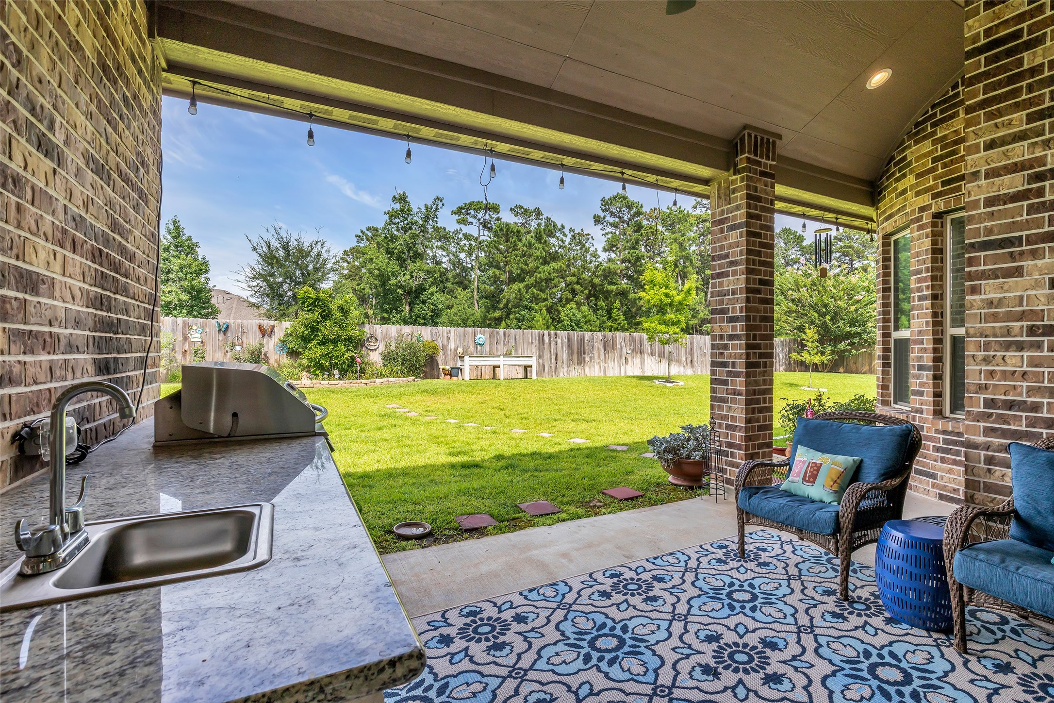 14003 South Evergreen Ridge Court Conroe, TX 77384 - Photo 32 of 43 Covered patio overlooks a spacious backyard with peaceful greenbelt views and no direct rear neighbors.