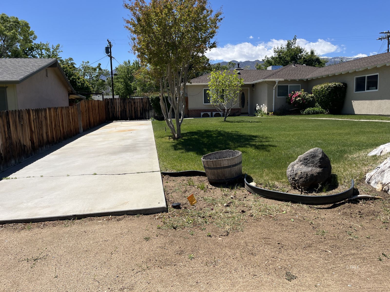 3012 Mesquite Road Bishop, CA 93514 - Photo 4 of 26 a white house that has a big yard and a fountain