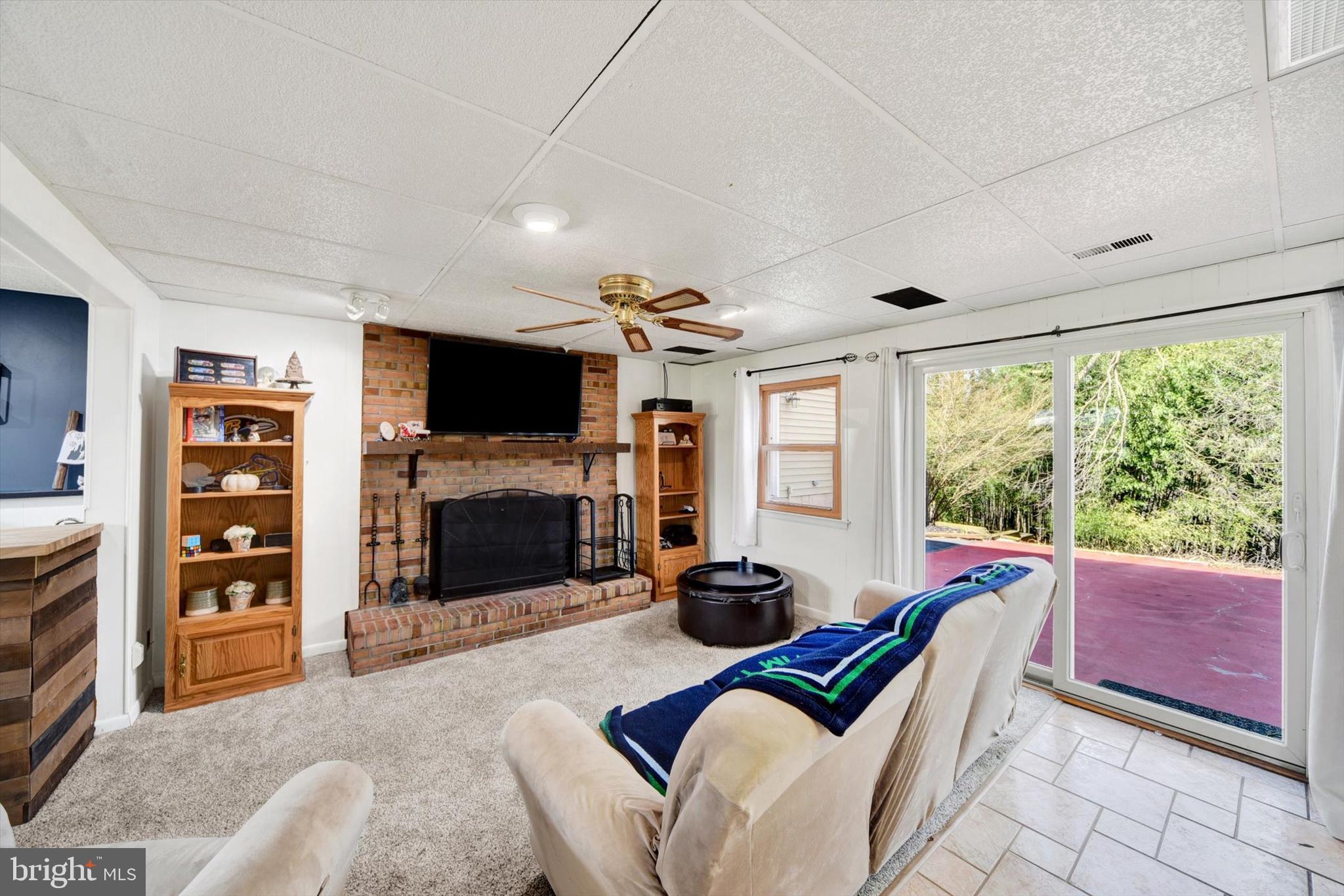 1504 Groveton Court Fallston, MD 21047 - Photo 20 of 29 a living room with furniture a fireplace and a flat screen tv