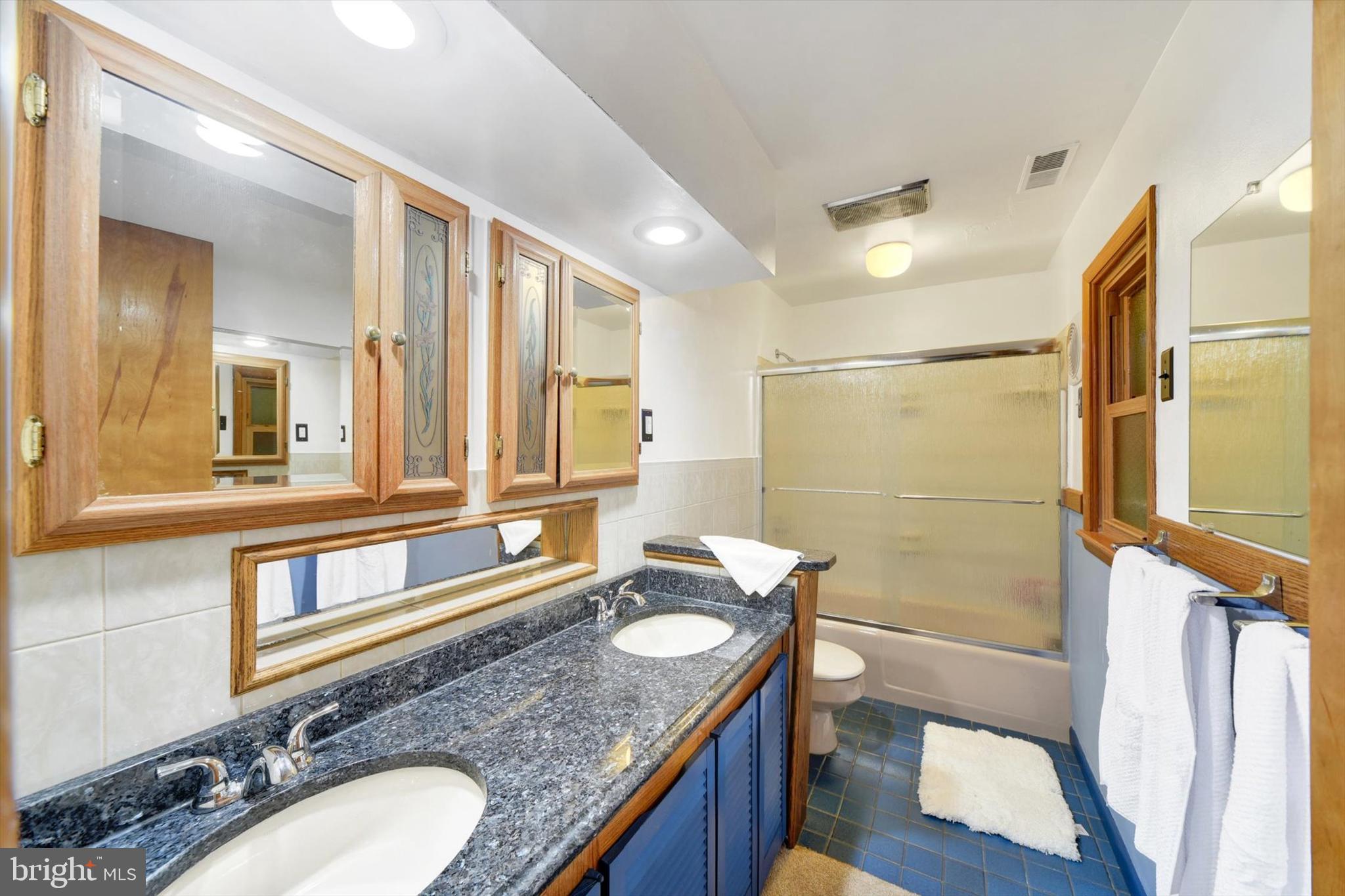 1504 Groveton Court Fallston, MD 21047 - Photo 27 of 29 a bathroom with a granite countertop double vanity sink and a mirror