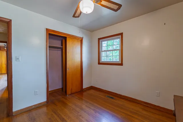 a view of a livingroom with couch and a ceiling fan