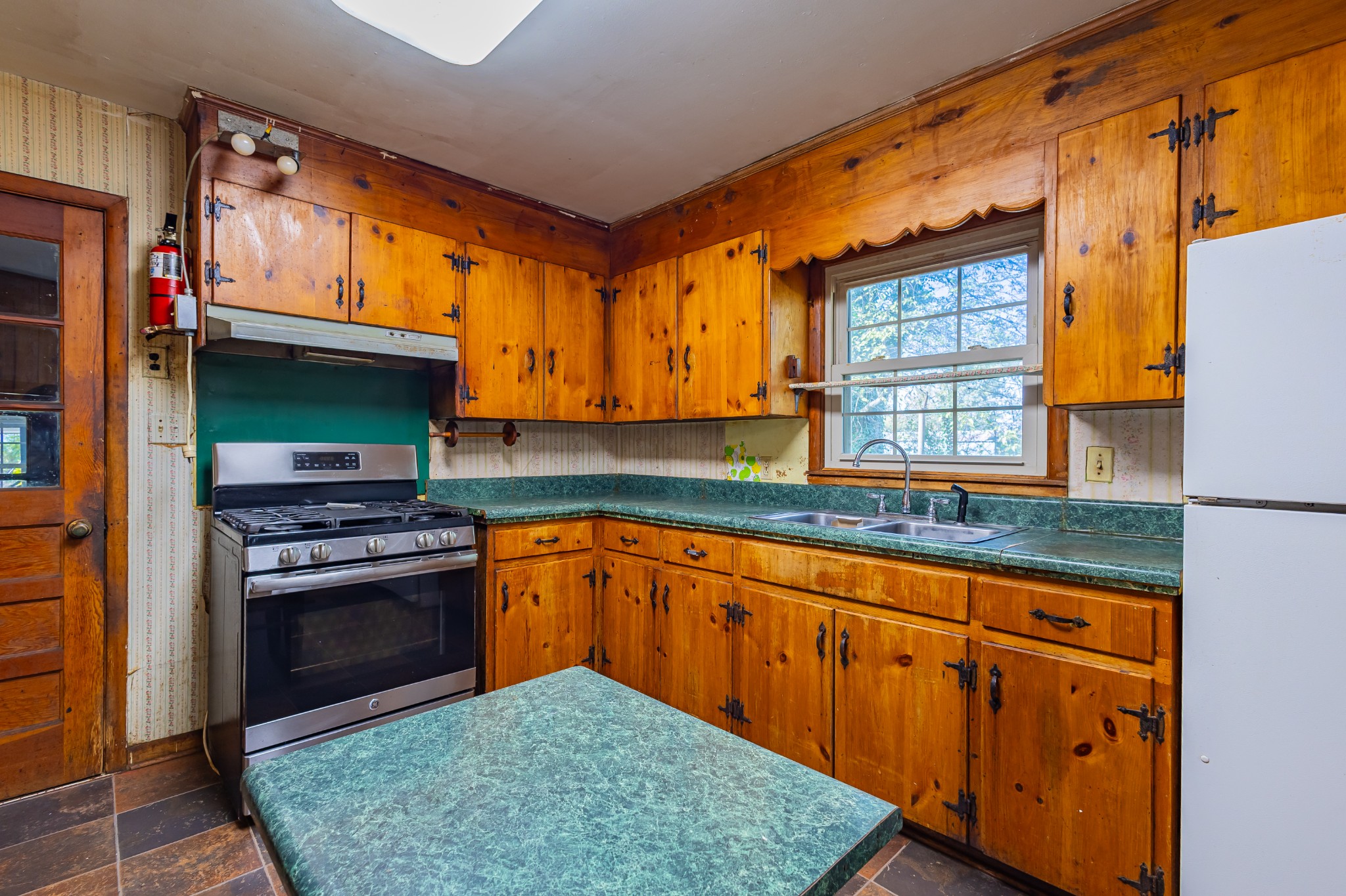 340 Yates Road Hillsboro, TN 37342 - Photo 44 of 69 a kitchen with granite countertop a sink cabinets stainless steel appliances and a counter space