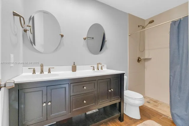 a spacious bathroom with a double vanity sink mirror and toilet