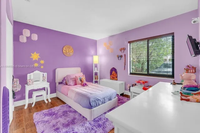 a bedroom with pink walls and pink walls
