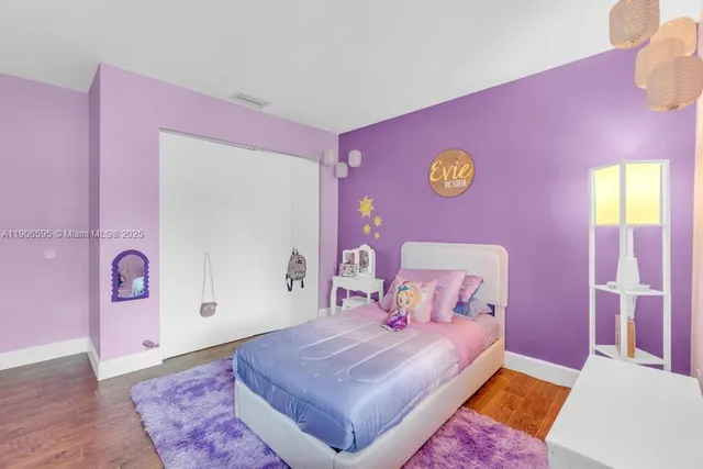 a bedroom with pink walls and pink rug