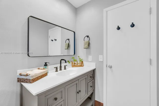 a bathroom with a sink and a mirror