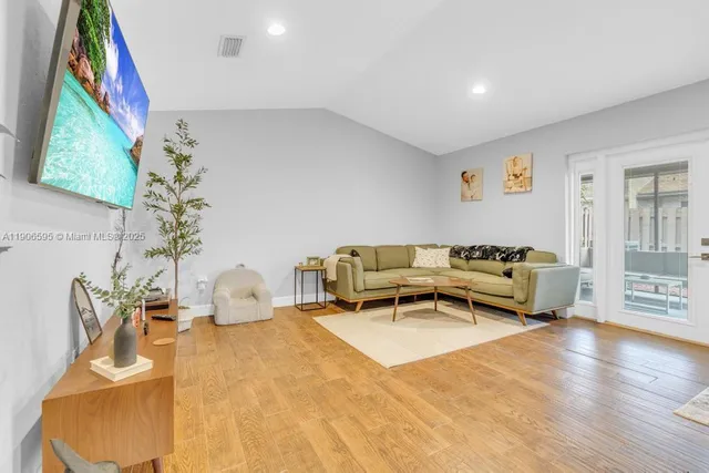 a living room with furniture and a painting on the wall