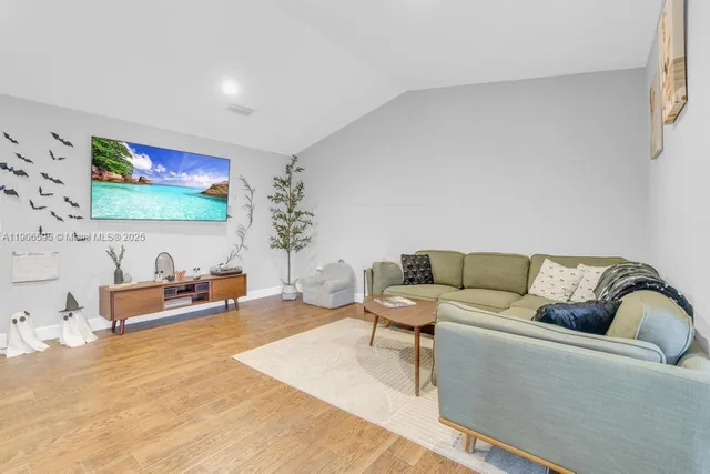a living room with furniture and a flat screen tv
