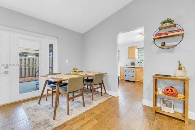 a dining room with a wooden table and chairs