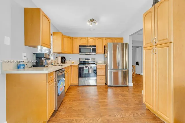 a kitchen with stainless steel appliances a refrigerator and a stove