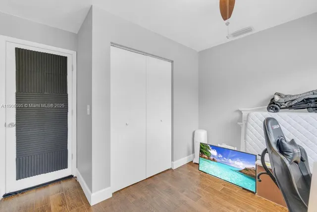 a view of workspace with wooden floor and bedroom
