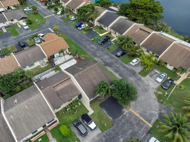 an aerial view of a house with a yard