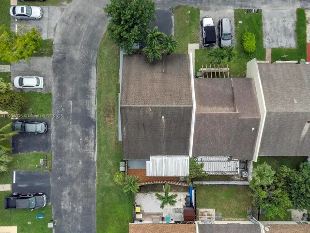 aerial view of a house with a garden and plants