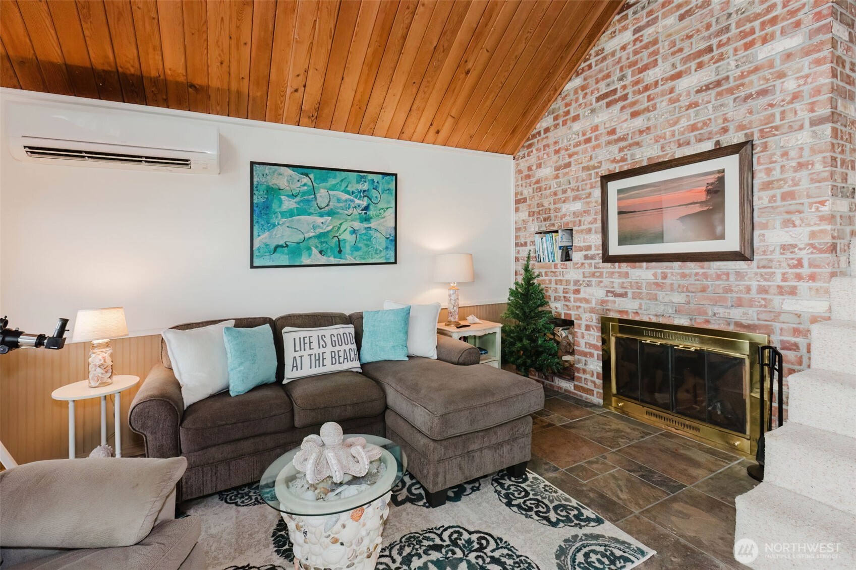 10271 Northeast North Shore Road Belfair, WA 98528 - Photo 13 of 38 a living room with furniture and a fireplace