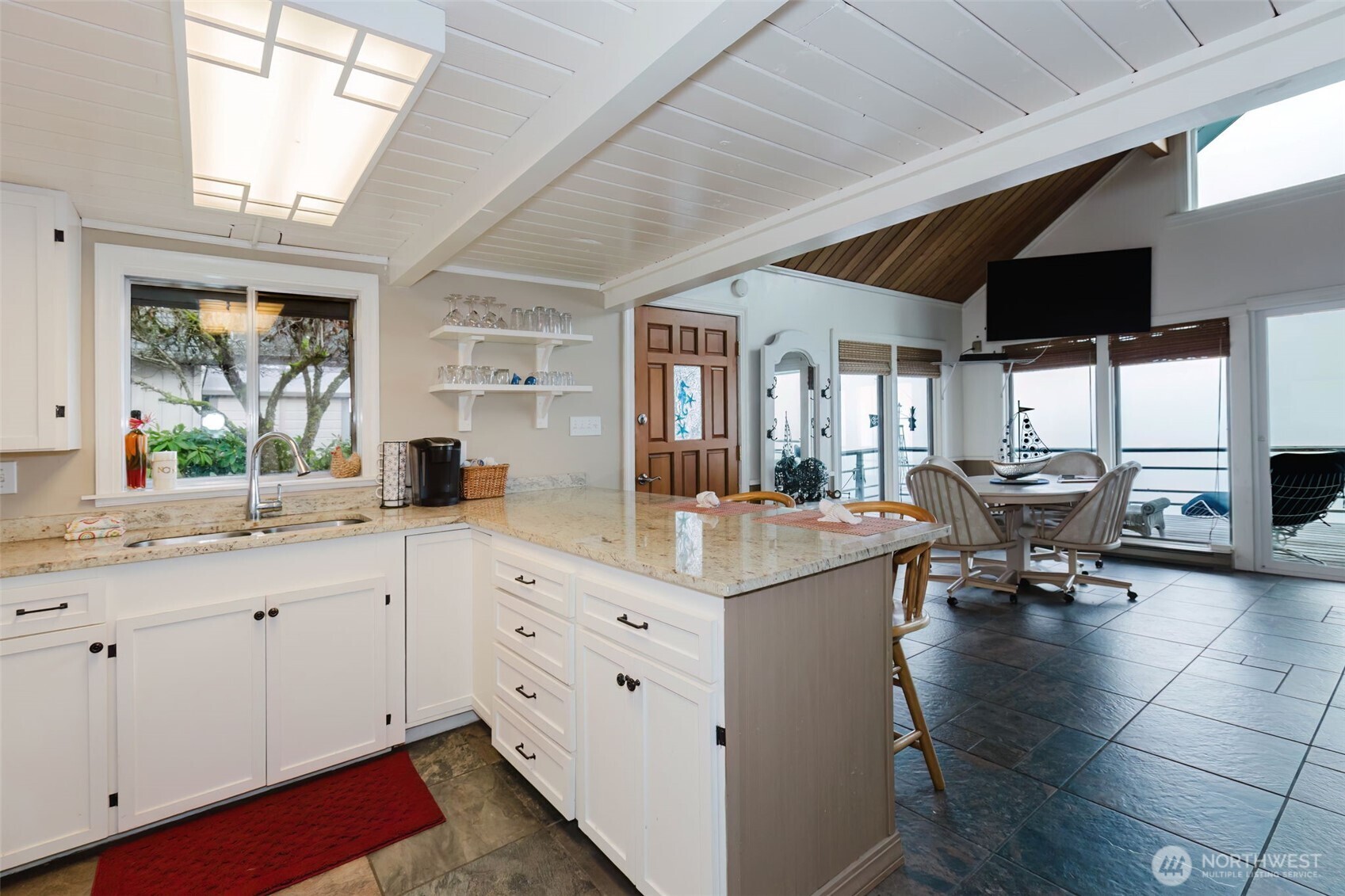 10271 Northeast North Shore Road Belfair, WA 98528 - Photo 19 of 38 a open kitchen with stainless steel appliances granite countertop a sink and cabinets