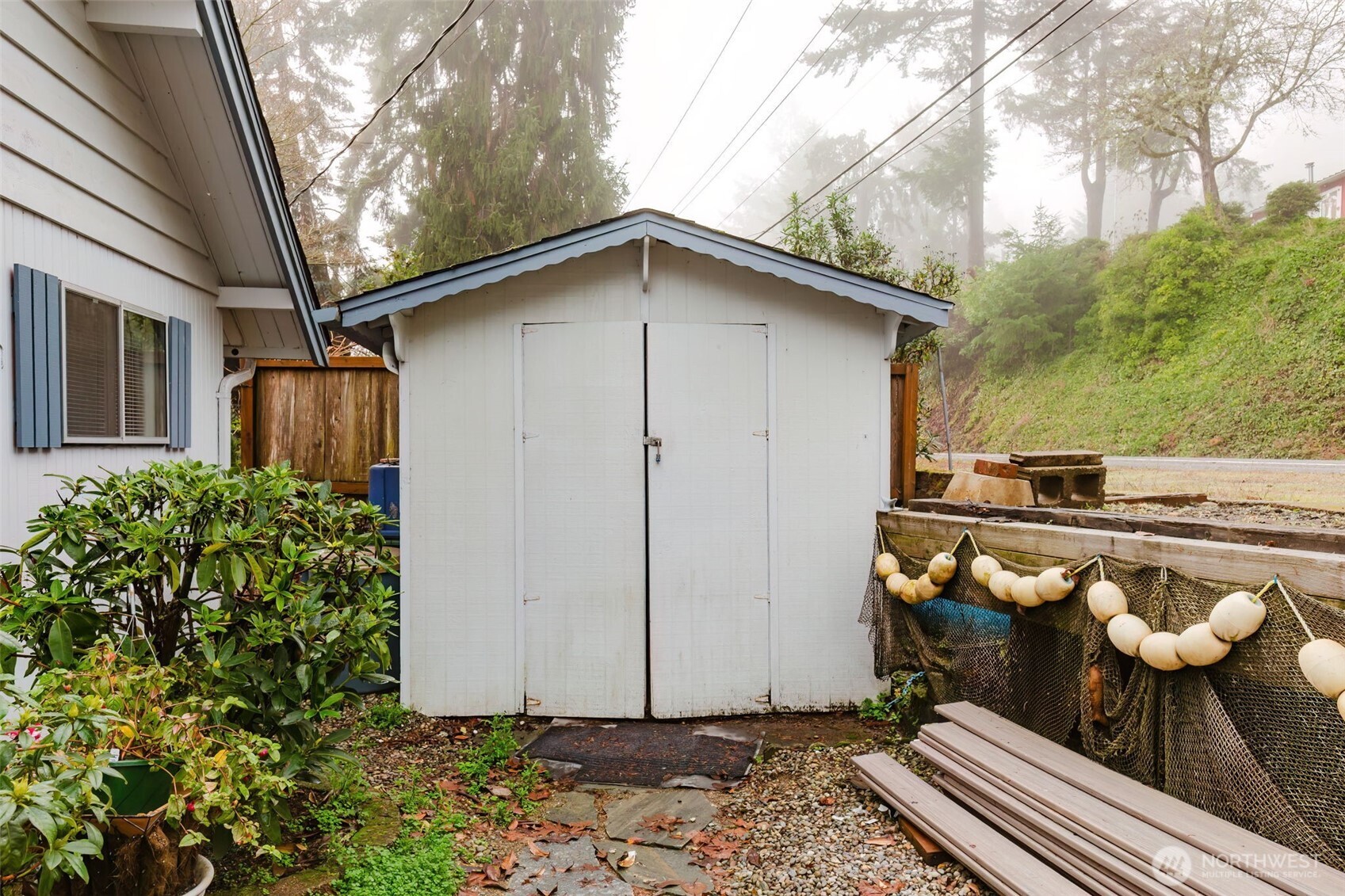 10271 Northeast North Shore Road Belfair, WA 98528 - Photo 29 of 38 a backyard of a house with barbeque oven table and chairs
