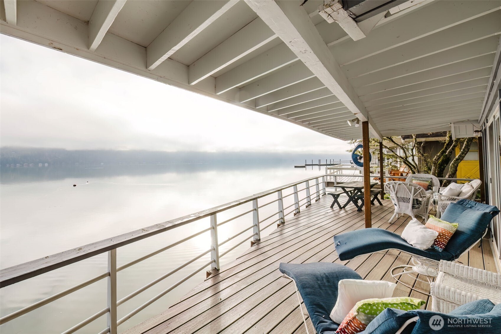 10271 Northeast North Shore Road Belfair, WA 98528 - Photo 7 of 38 a view of a balcony with furniture and wooden floor
