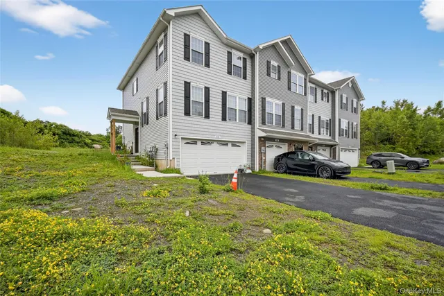 a view of a big house with a yard