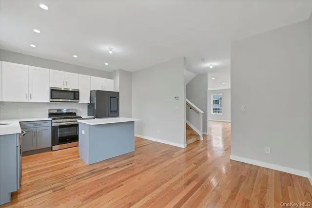 a kitchen with stainless steel appliances a refrigerator and a stove top oven