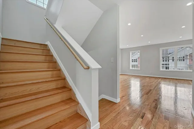 a view of entryway and hall with wooden floor