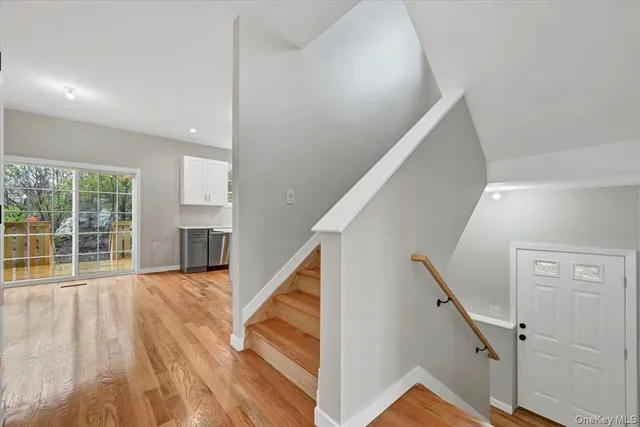 a view of an entryway with wooden floor