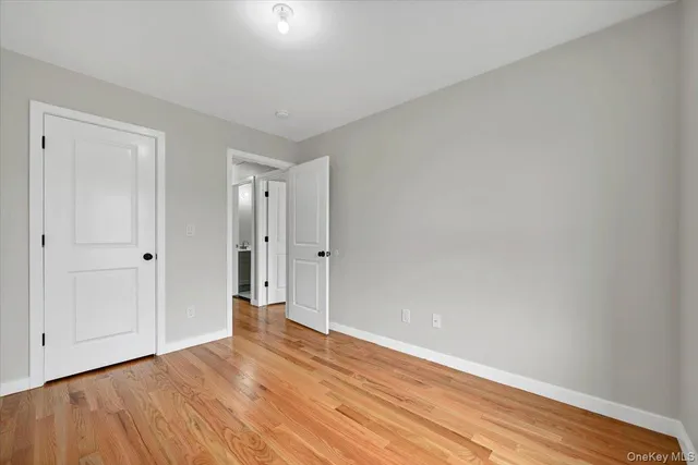a view of an empty room and wooden floor